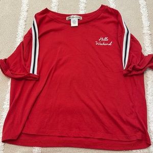 A red T-shirt with black and white stripes on the arm(worn a couple times)